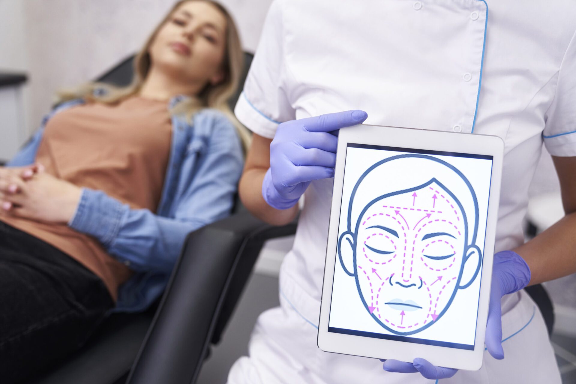 Doctor presenting digital tablet with face lifting sketch Dr. Ramsey Joudeh, MD treatment on procressing